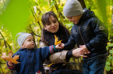 two-boys-and-woman-surrounded-green-plants-1497530